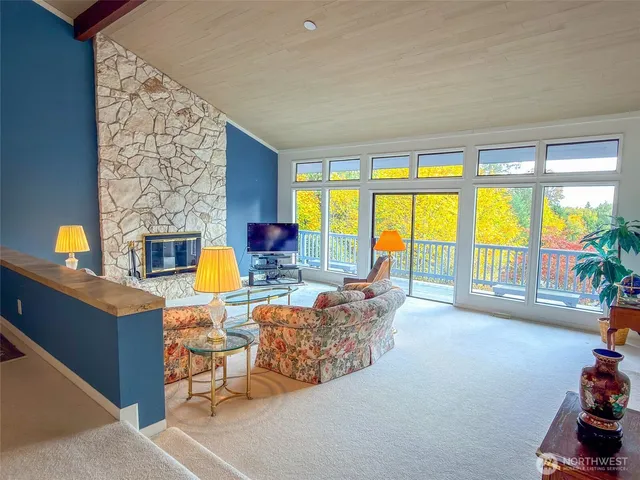a living room with furniture and floor to ceiling windows