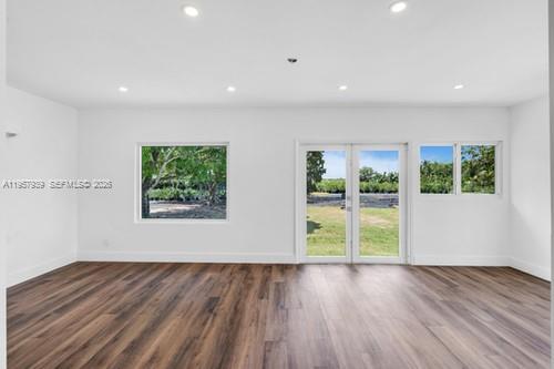 13770 Southwest 192nd Street Miami, FL 33177 - Photo 12 of 28 a view of an empty room with wooden floor and a window