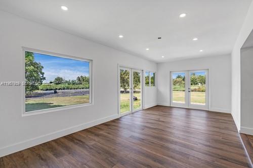 13770 Southwest 192nd Street Miami, FL 33177 - Photo 13 of 28 a view of an empty room with wooden floor and a window