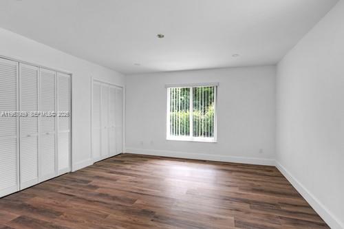 13770 Southwest 192nd Street Miami, FL 33177 - Photo 15 of 28 a view of an empty room with wooden floor and a window