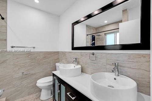 13770 Southwest 192nd Street Miami, FL 33177 - Photo 16 of 28 a bathroom with a toilet sink and mirror