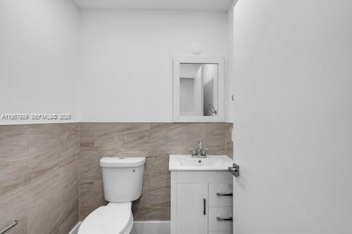 13770 Southwest 192nd Street Miami, FL 33177 - Photo 18 of 28 a bathroom with a toilet sink and mirror