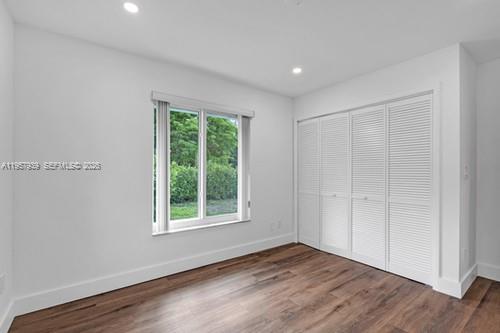 13770 Southwest 192nd Street Miami, FL 33177 - Photo 20 of 28 a view of an empty room with wooden floor and a window