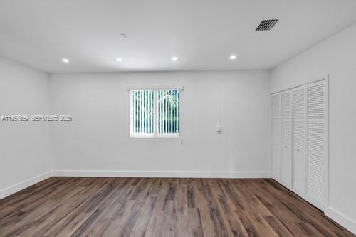 13770 Southwest 192nd Street Miami, FL 33177 - Photo 22 of 28 an empty room with wooden floor and windows