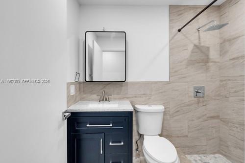 13770 Southwest 192nd Street Miami, FL 33177 - Photo 23 of 28 a bathroom with a toilet sink and mirror