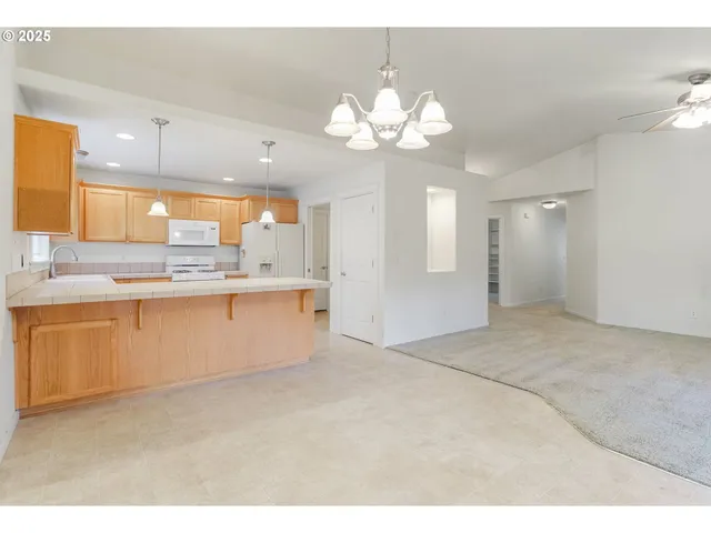 a kitchen with a refrigerator a sink and cabinets