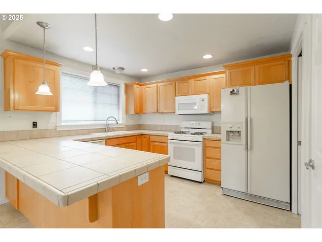 a kitchen with a sink cabinets and window