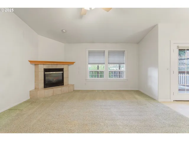 a view of empty room with a fireplace