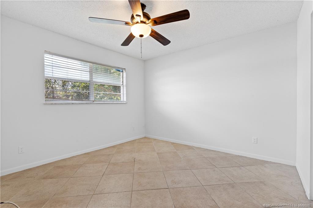 2118 Southeast Edler Drive, Unit B Stuart, FL 34994 - Photo 11 of 20 an empty room with windows and fan