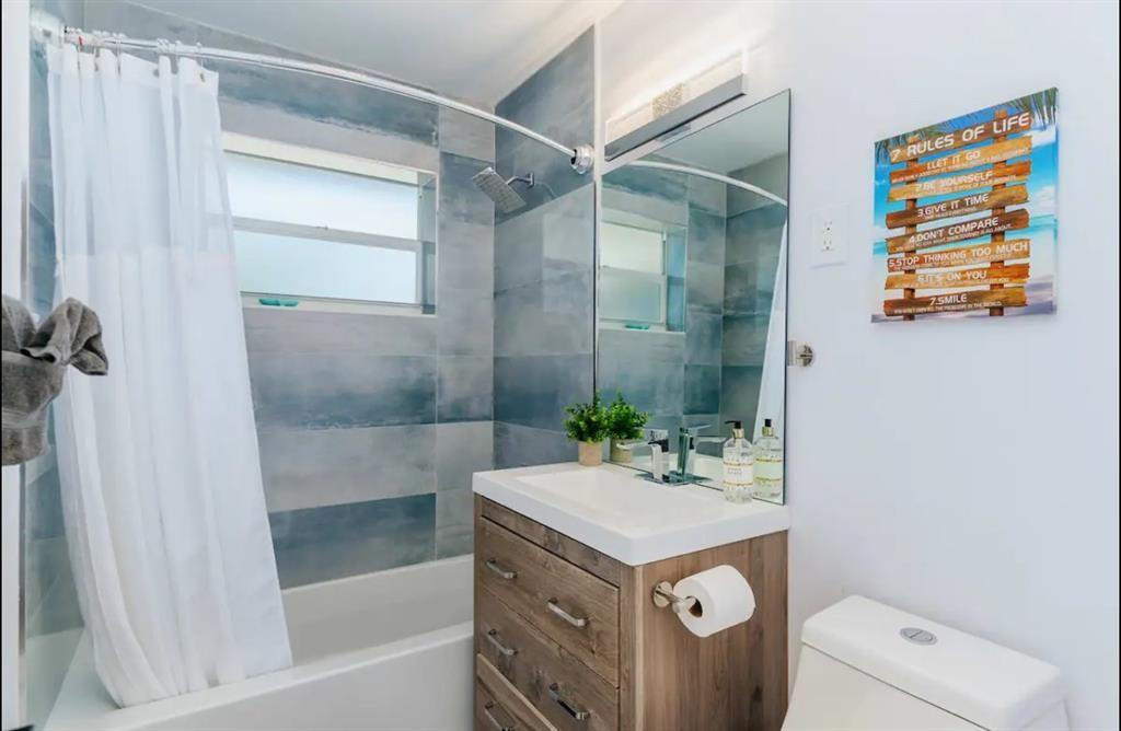 2521 Northeast 51st Street Lighthouse Point, FL 33064 - Photo 15 of 24 a bathroom with a sink a toilet and shower