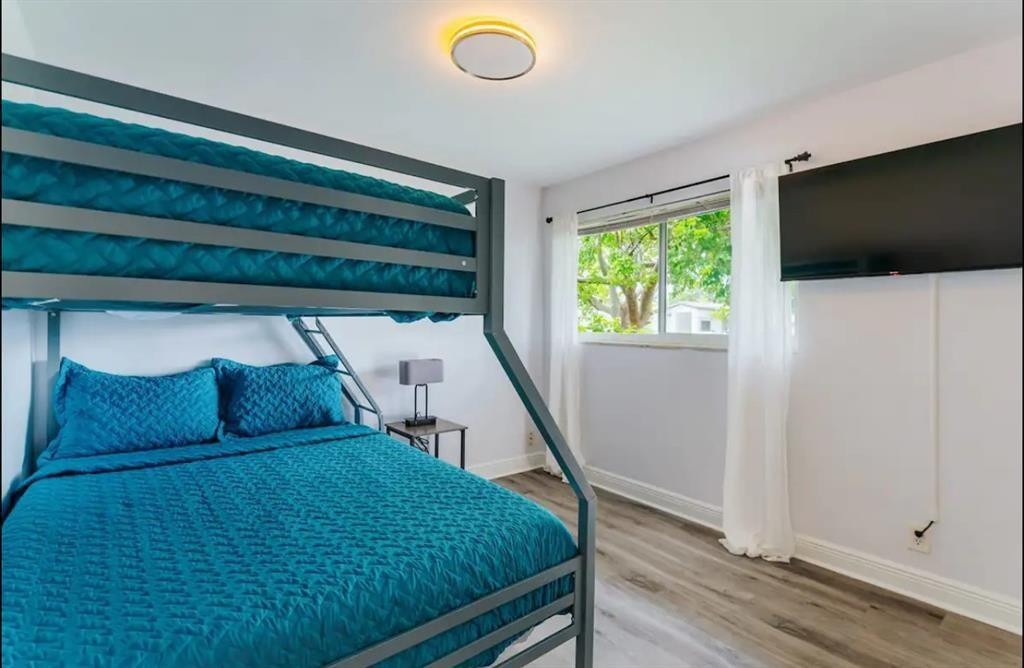 2521 Northeast 51st Street Lighthouse Point, FL 33064 - Photo 18 of 24 a bed room with a bed tv and a window