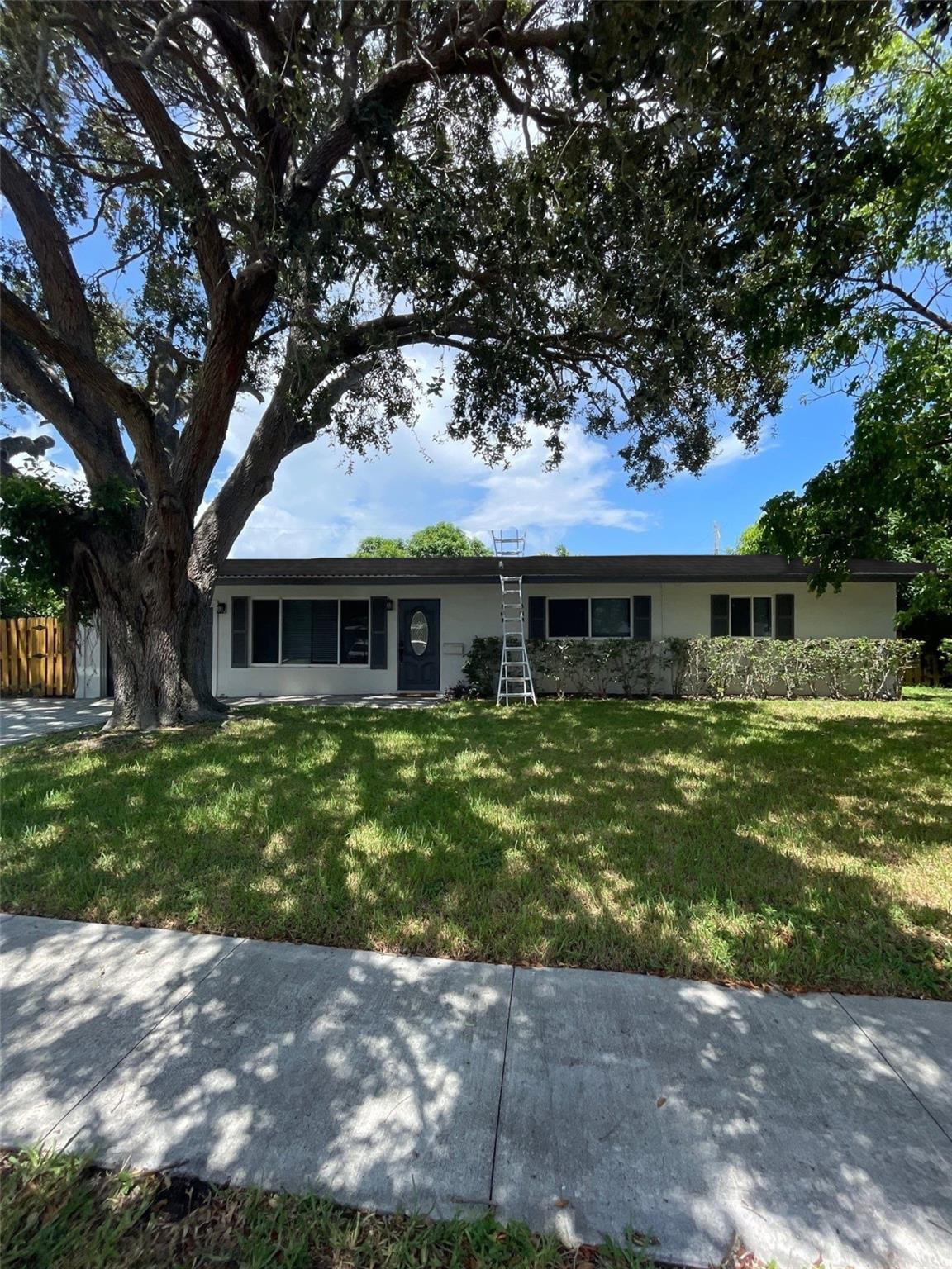 2521 Northeast 51st Street Lighthouse Point, FL 33064 - Photo 23 of 24 a front view of a house with a garden
