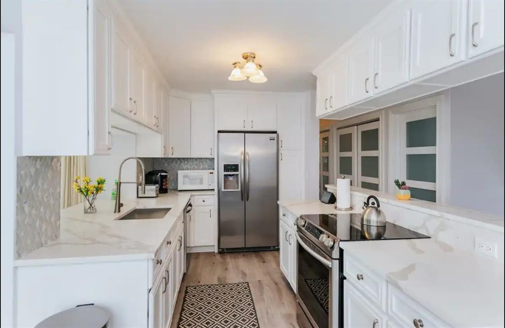 2521 Northeast 51st Street Lighthouse Point, FL 33064 - Photo 4 of 24 a kitchen with a sink stove and refrigerator