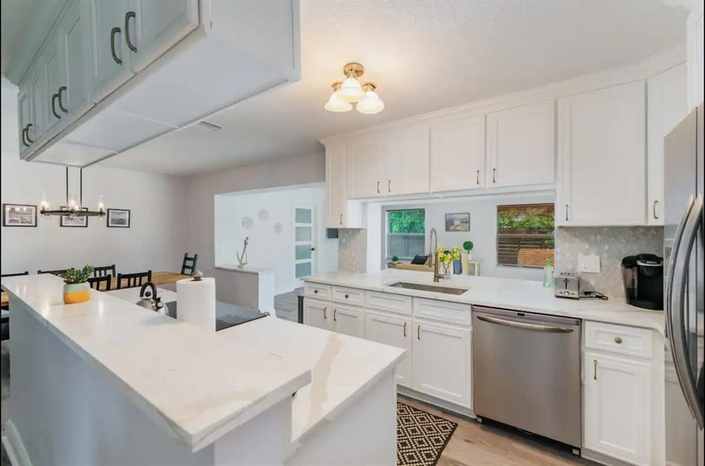 2521 Northeast 51st Street Lighthouse Point, FL 33064 - Photo 5 of 24 a kitchen that has a lot of white cabinets and wooden floor