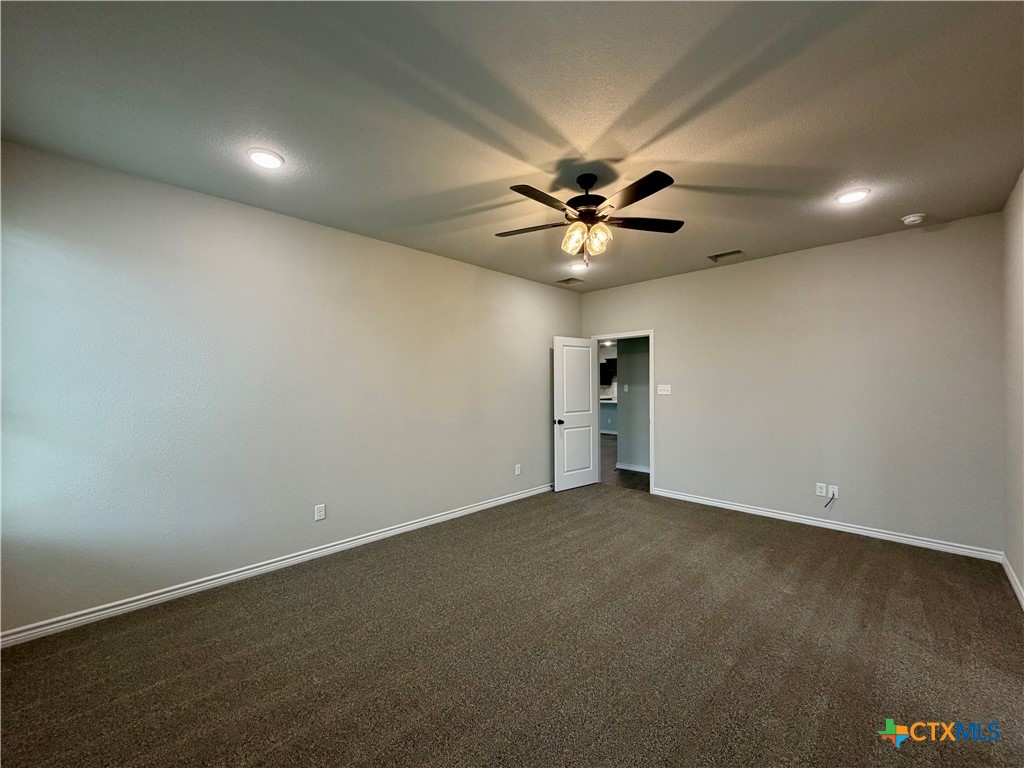 6903 Wizard Drive Killeen, TX 76549 - Photo 11 of 23 an empty room with a ceiling fan and a window