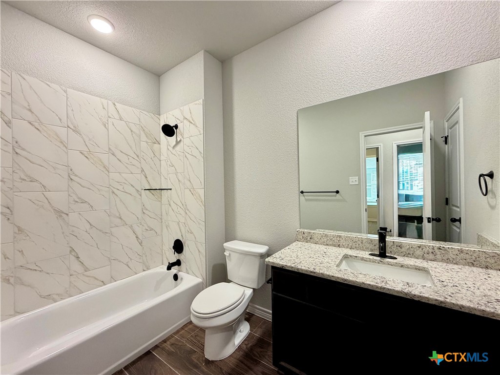 6903 Wizard Drive Killeen, TX 76549 - Photo 18 of 23 a bathroom with a granite countertop bathtub sink vanity mirror and toilet