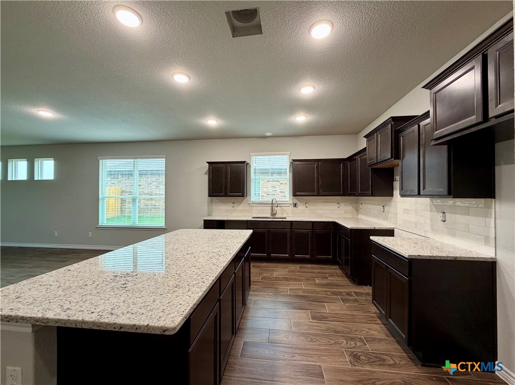 6903 Wizard Drive Killeen, TX 76549 - Photo 4 of 23 a kitchen with stainless steel appliances granite countertop a sink stove and refrigerator