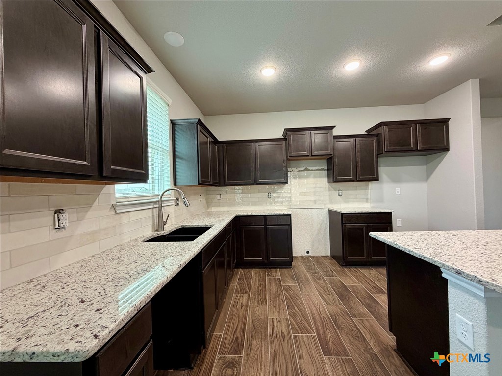 6903 Wizard Drive Killeen, TX 76549 - Photo 5 of 23 a large kitchen with a large counter top sink and stainless steel appliances