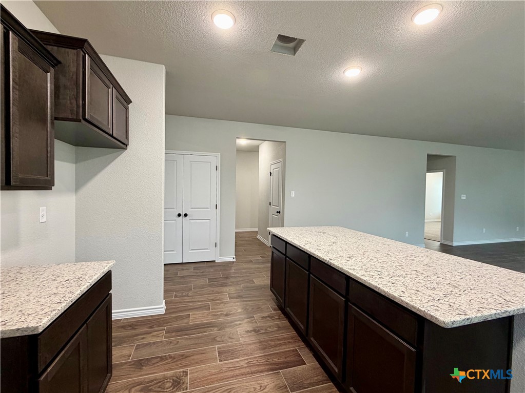 6903 Wizard Drive Killeen, TX 76549 - Photo 6 of 23 a bathroom with a granite countertop sink a toilet and shower