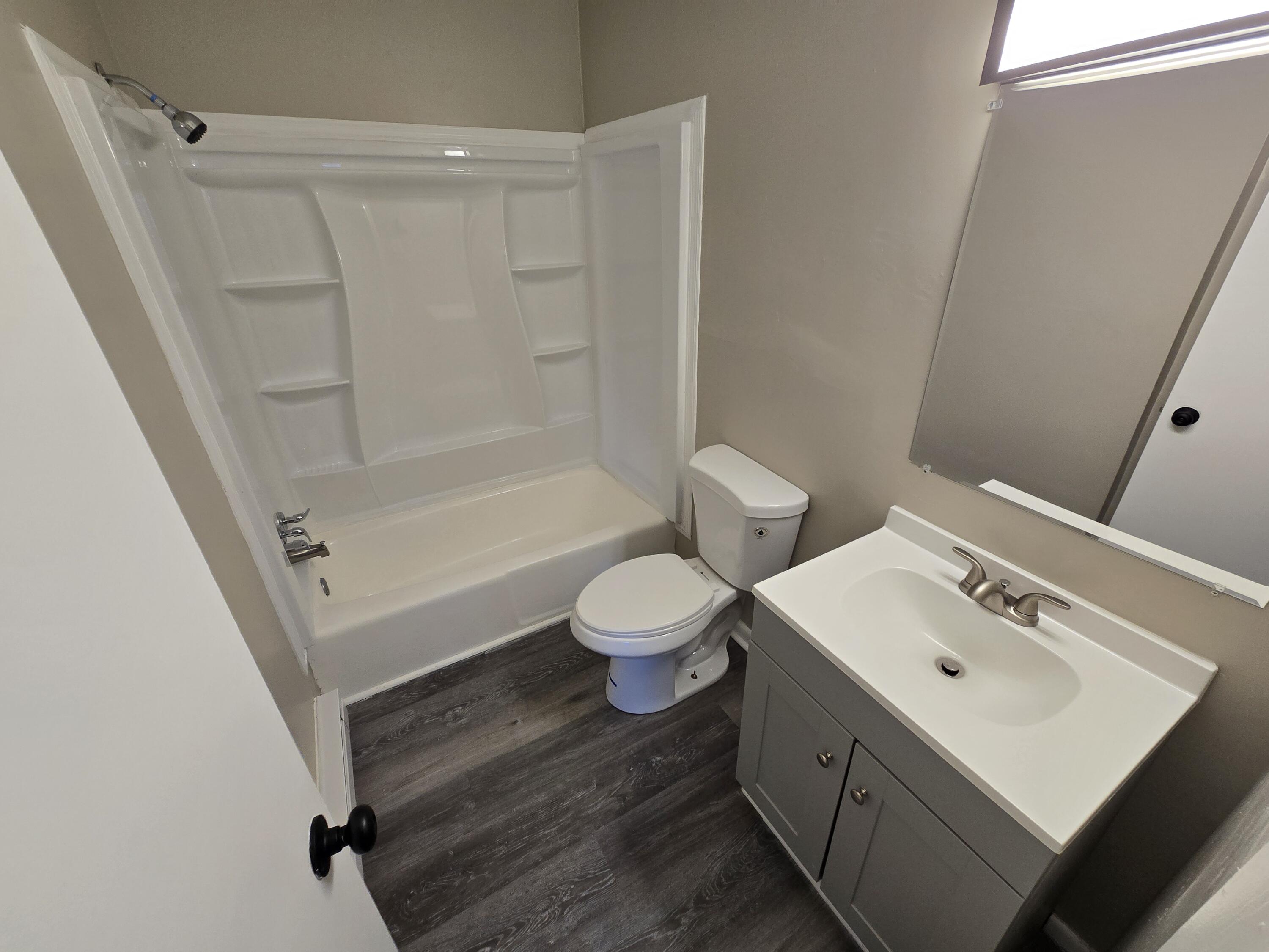 2646 Westover Avenue Southwest, Unit 8 Roanoke, VA 24015 - Photo 5 of 6 a bathroom with a sink a toilet and a mirror