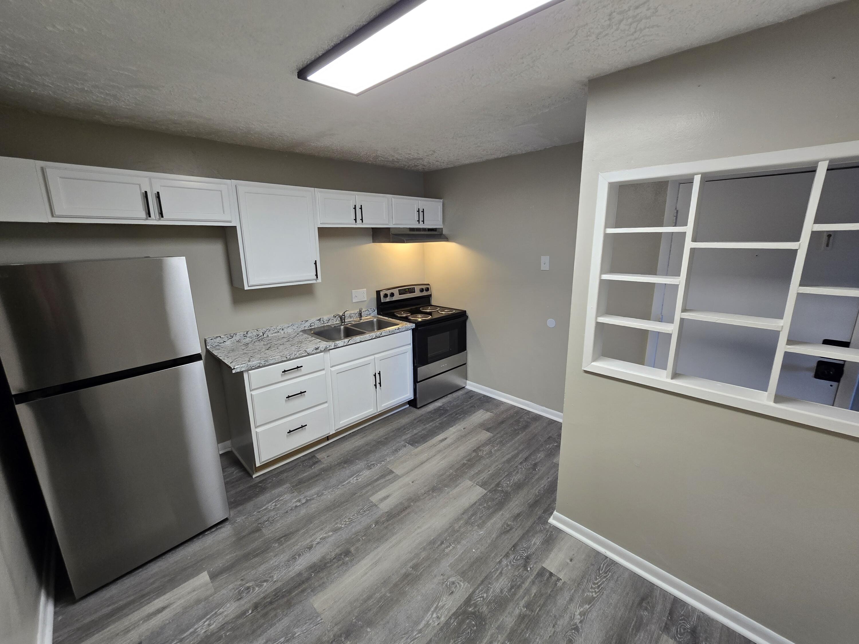 2646 Westover Avenue Southwest, Unit 8 Roanoke, VA 24015 - Photo 6 of 6 a kitchen with a refrigerator and a stove