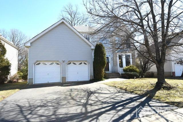 42 Timber Ridge Road North Brunswick, NJ 08902 - Photo 34 of 43 a front view of a house with a yard covered with snow