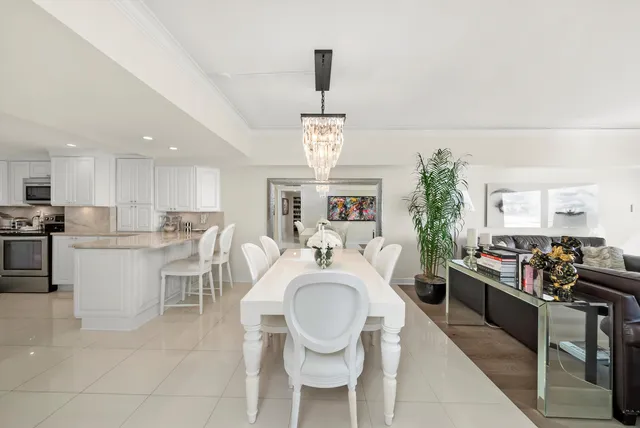 a very nice looking dining room with a large window and stainless steel appliances