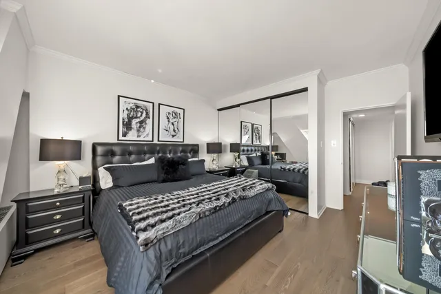 a bedroom with a bed and wooden floor