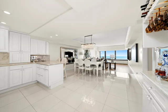 a kitchen with a sink and chairs