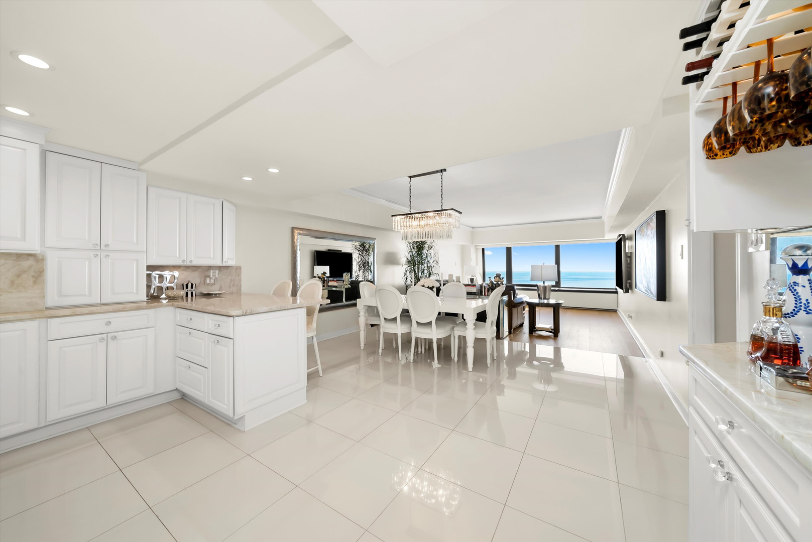 175 East Delaware Place, Unit 7107 Chicago, IL 60611 - Photo 2 of 42 a kitchen with a sink and chairs