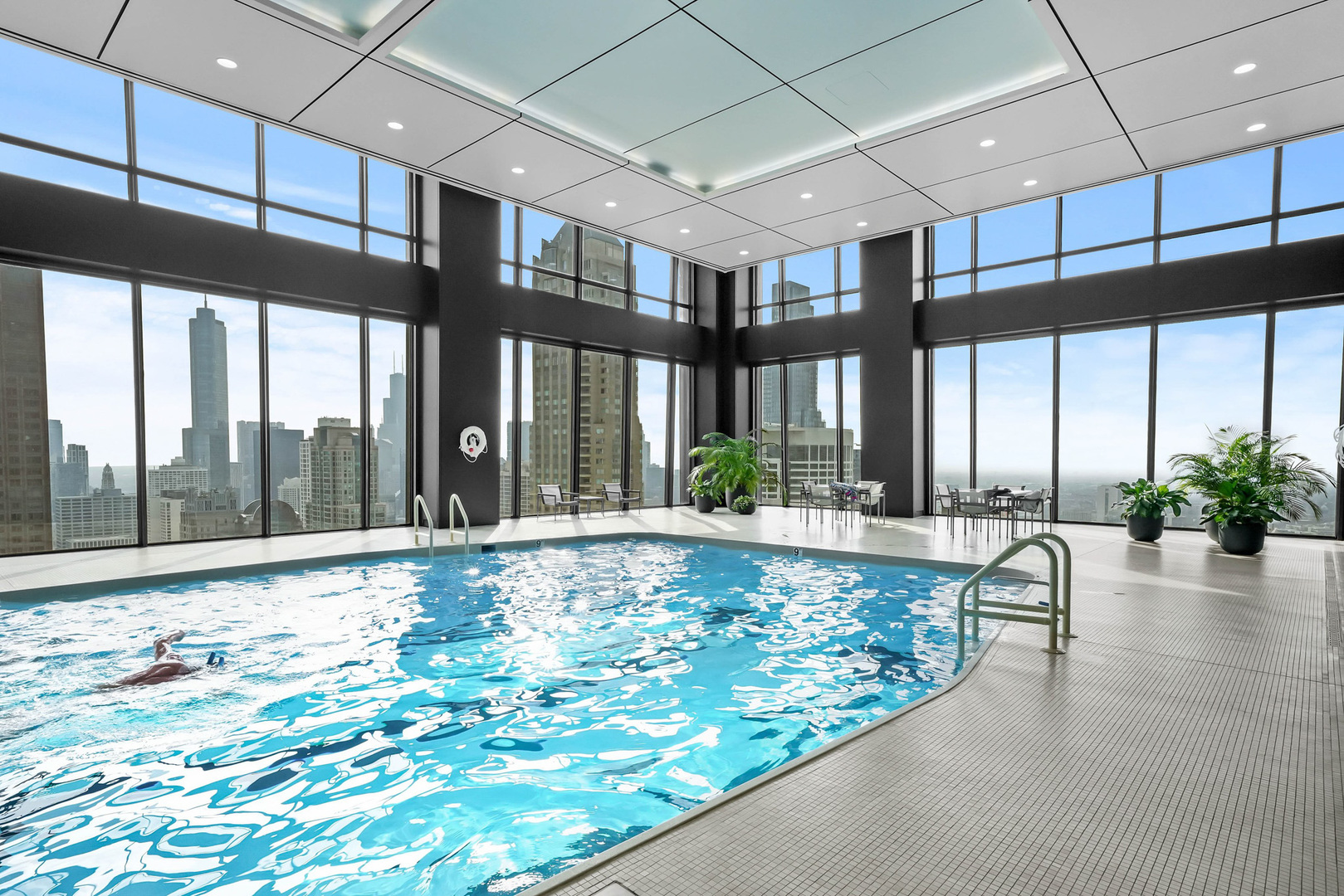 175 East Delaware Place, Unit 7107 Chicago, IL 60611 - Photo 25 of 42 a swimming pool with large windows and outdoor seating
