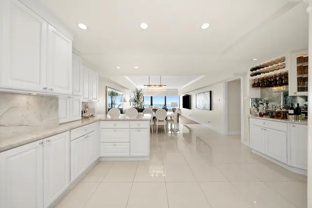 a kitchen with white cabinets and sink