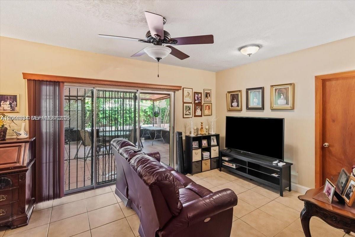 6385 Southwest 25th Street Miami, FL 33155 - Photo 9 of 28 a living room with furniture and a flat screen tv