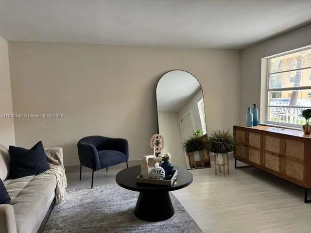 a living room with furniture and a mirror