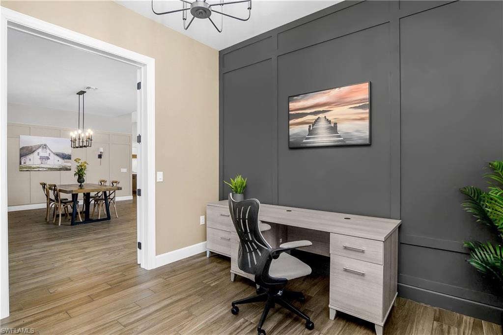 17570 Ashcomb Way Estero, FL 33928 - Photo 18 of 50 a work room with furniture and wooden floor