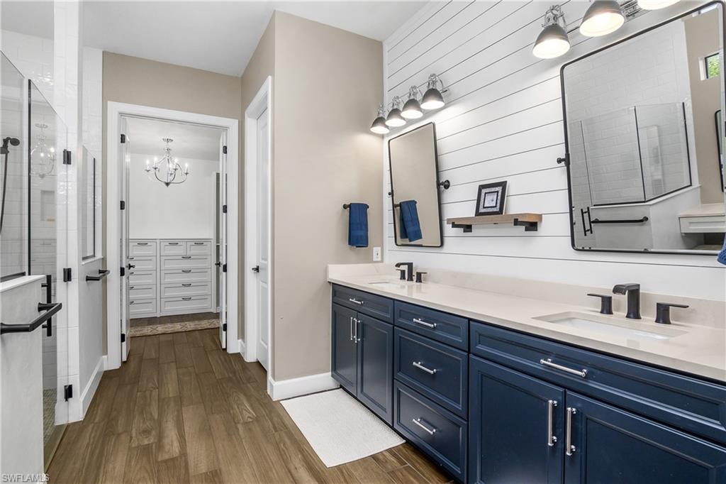 17570 Ashcomb Way Estero, FL 33928 - Photo 21 of 50 a spacious bathroom with a double vanity sink a mirror and shower