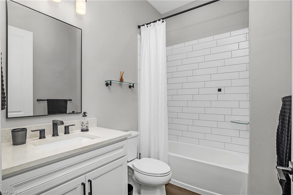 17570 Ashcomb Way Estero, FL 33928 - Photo 26 of 50 a bathroom with a sink a toilet and shower