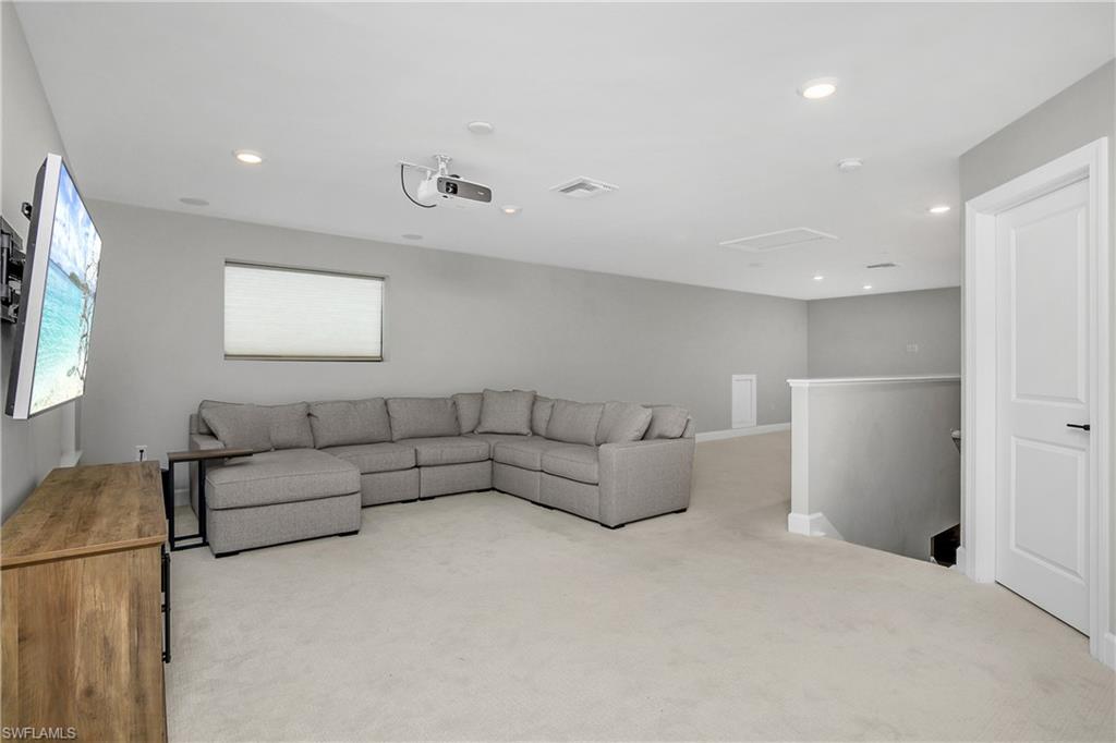 17570 Ashcomb Way Estero, FL 33928 - Photo 31 of 50 a living room with furniture and a flat screen tv