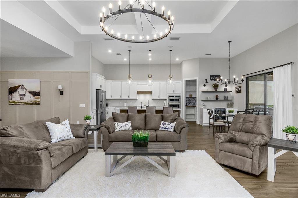 17570 Ashcomb Way Estero, FL 33928 - Photo 4 of 50 a living room with furniture kitchen and a chandelier