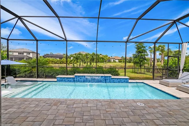 a patio with a table and chairs under an umbrella