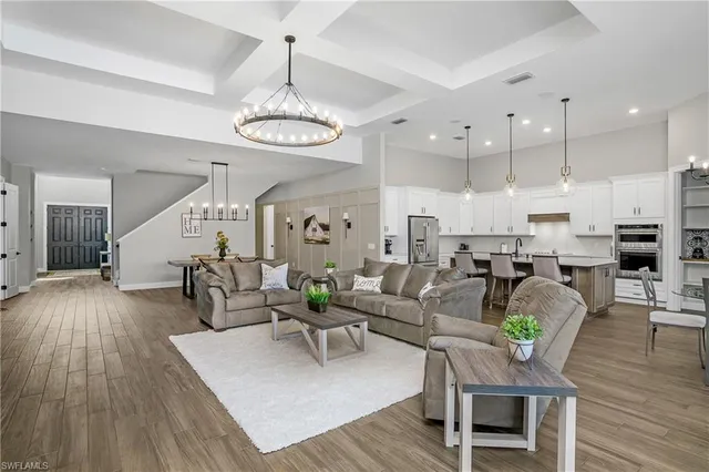 a living room with lots of furniture and kitchen view