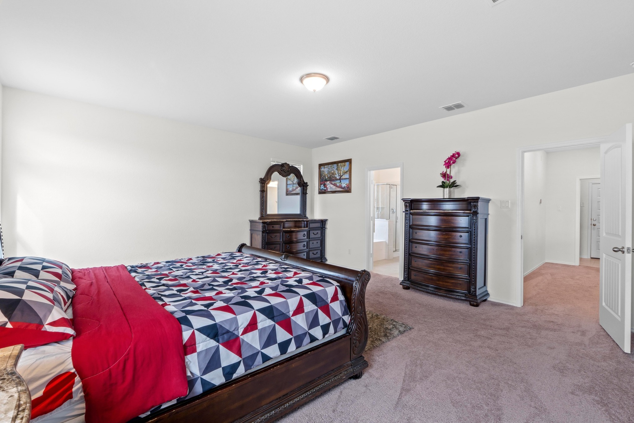 4729 San Rufo Drive Round Rock, TX 78665 - Photo 14 of 36 Spacious room featuring neutral wall paint, carpet flooring, a ceiling-mounted light fixture, and two open doorways revealing additional interior spaces