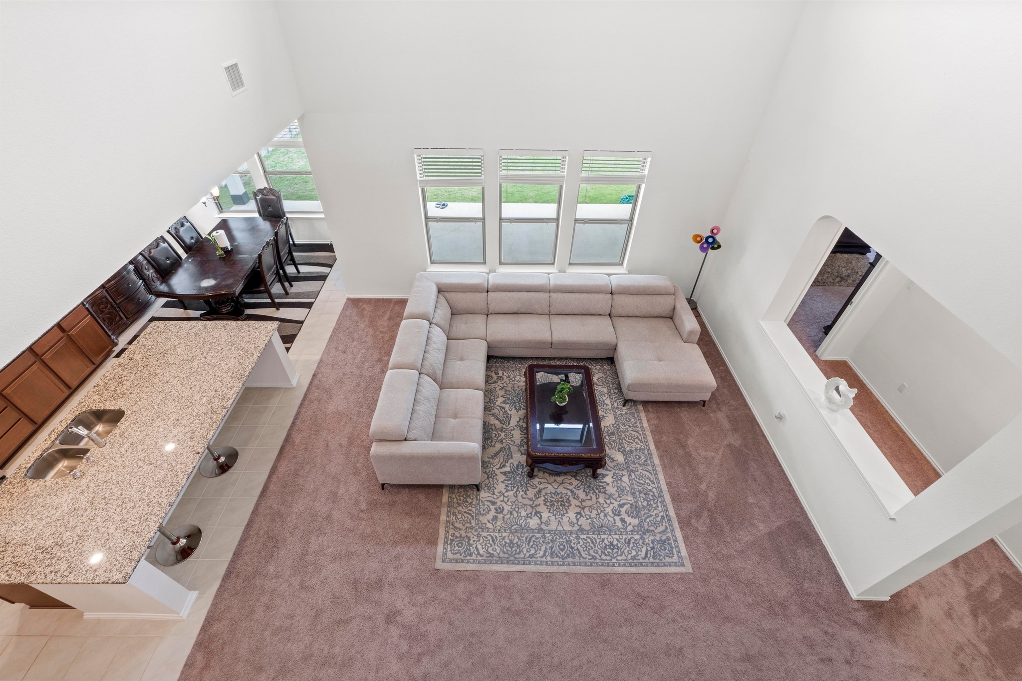 4729 San Rufo Drive Round Rock, TX 78665 - Photo 20 of 36 Two-story living area featuring a vaulted ceiling and three large windows