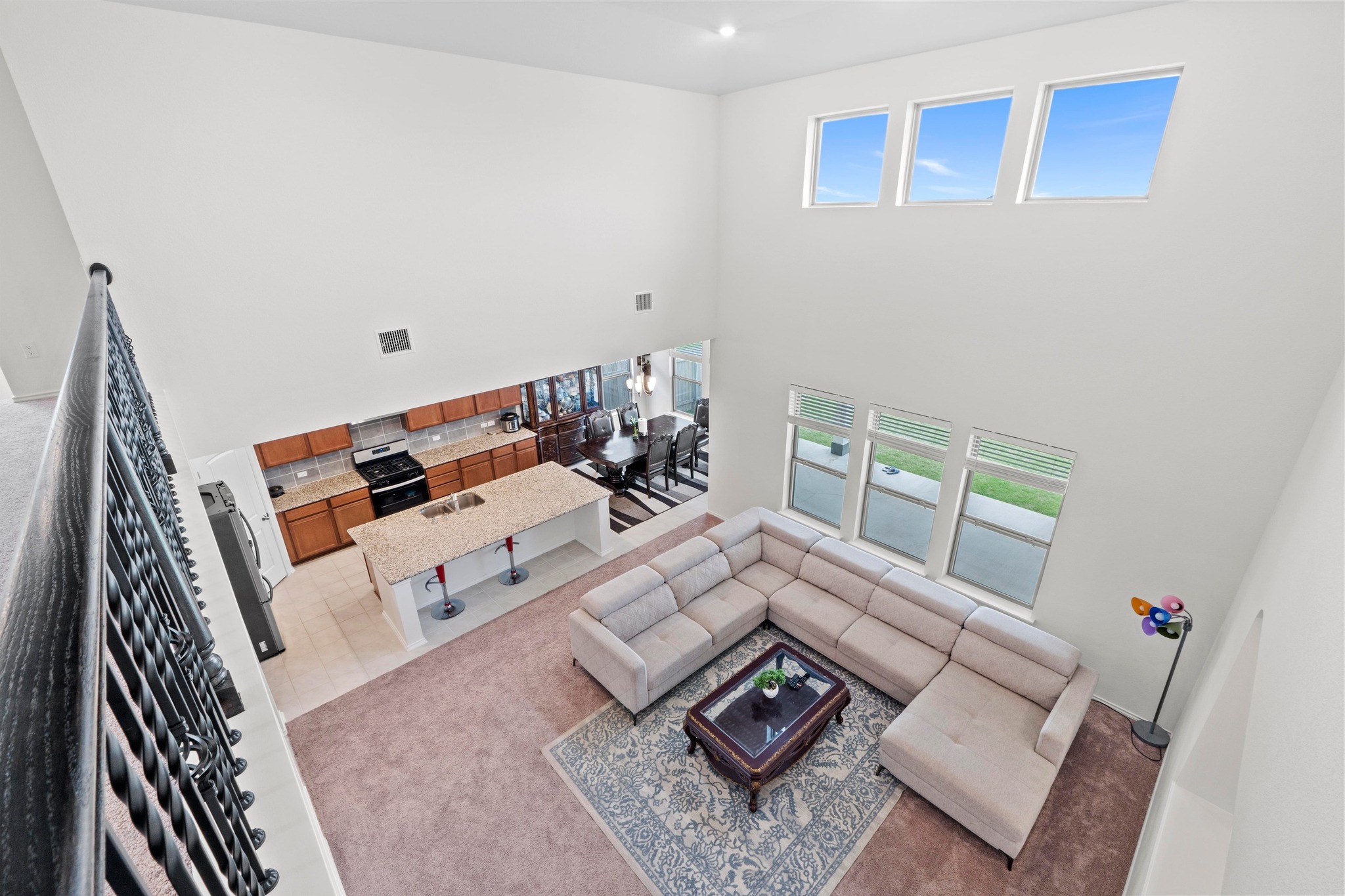 4729 San Rufo Drive Round Rock, TX 78665 - Photo 21 of 36 Spacious open-concept living area featuring a two-story ceiling and multiple windows