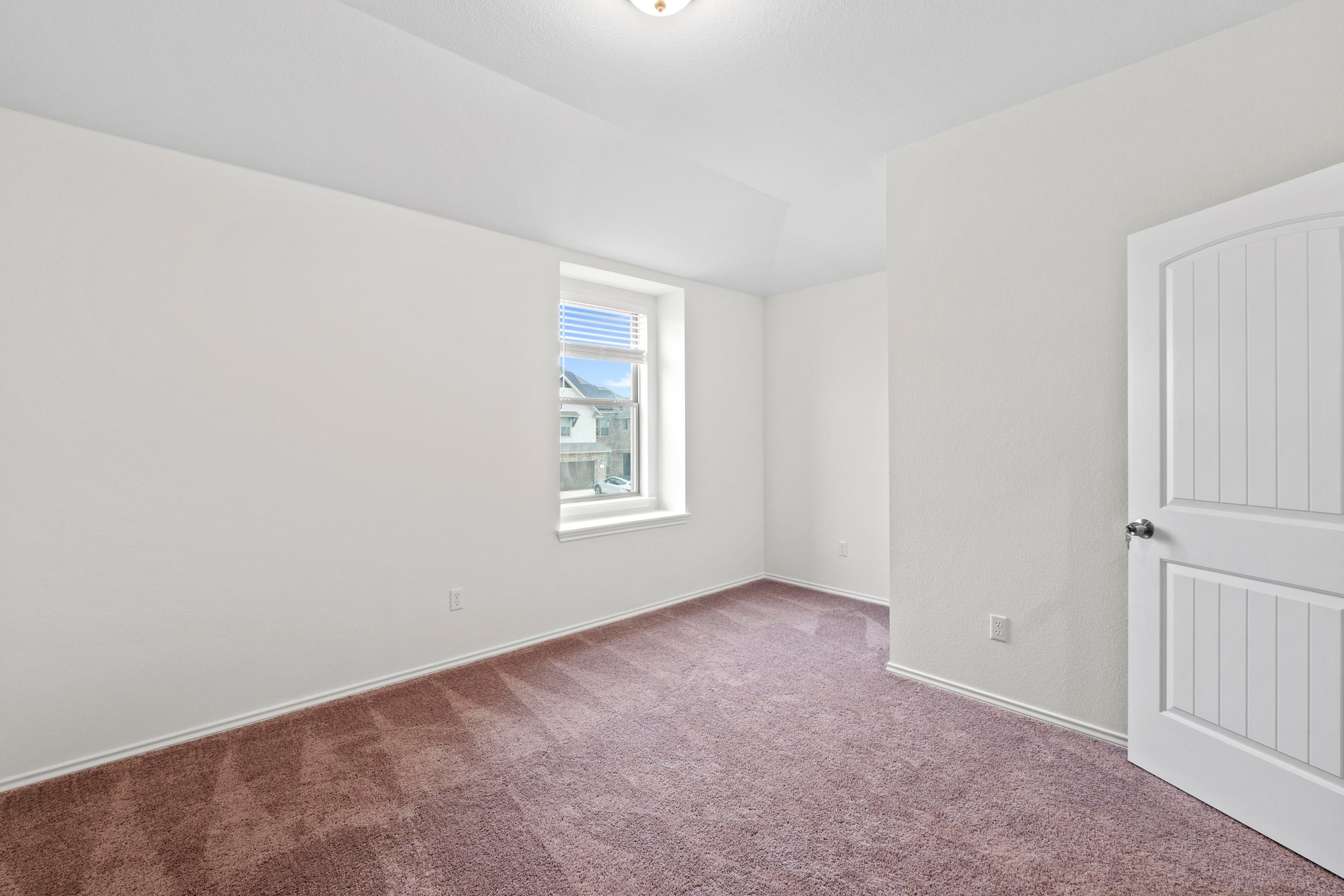 4729 San Rufo Drive Round Rock, TX 78665 - Photo 24 of 36 Inviting room featuring a single window, vaulted ceiling, and brown carpet