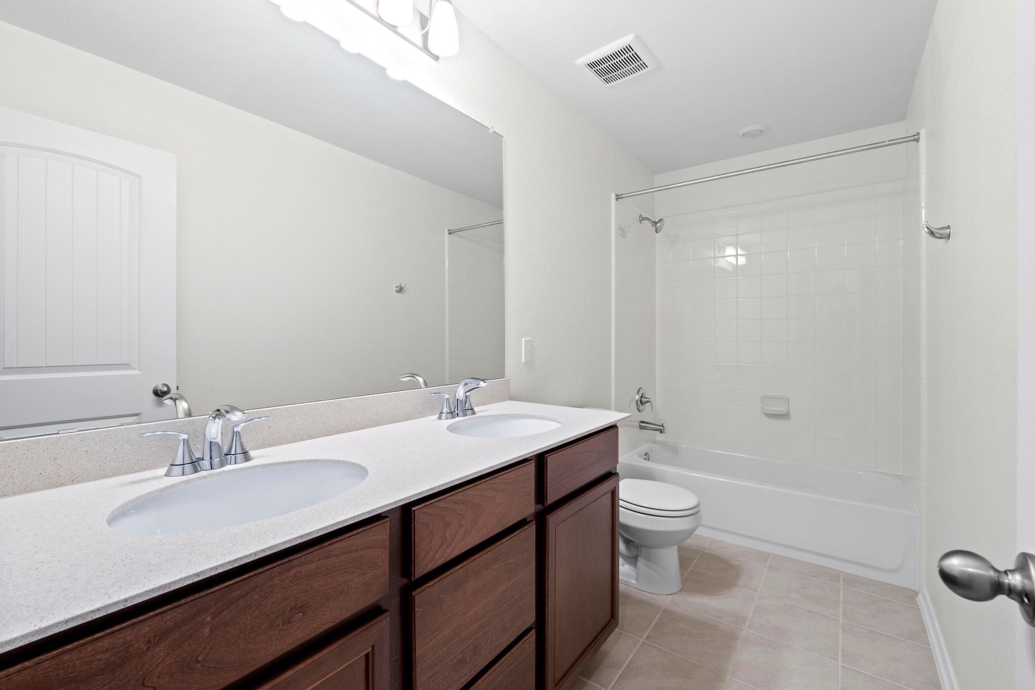 4729 San Rufo Drive Round Rock, TX 78665 - Photo 25 of 36 Bathroom featuring a dual-sink vanity with a light-colored countertop and dark wood-finish cabinetry