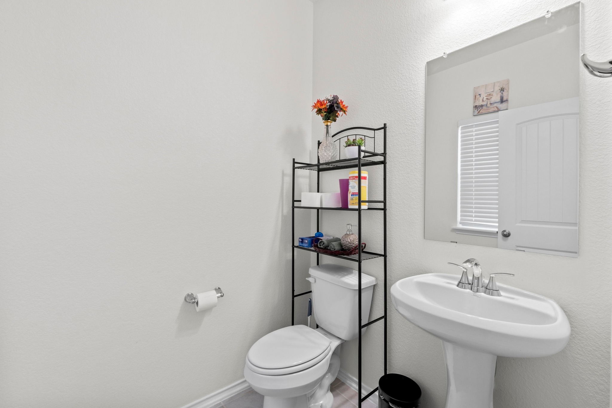 4729 San Rufo Drive Round Rock, TX 78665 - Photo 28 of 36 Bathroom featuring a white pedestal sink with a chrome faucet, a rectangular wall-mounted mirror, and a white toilet