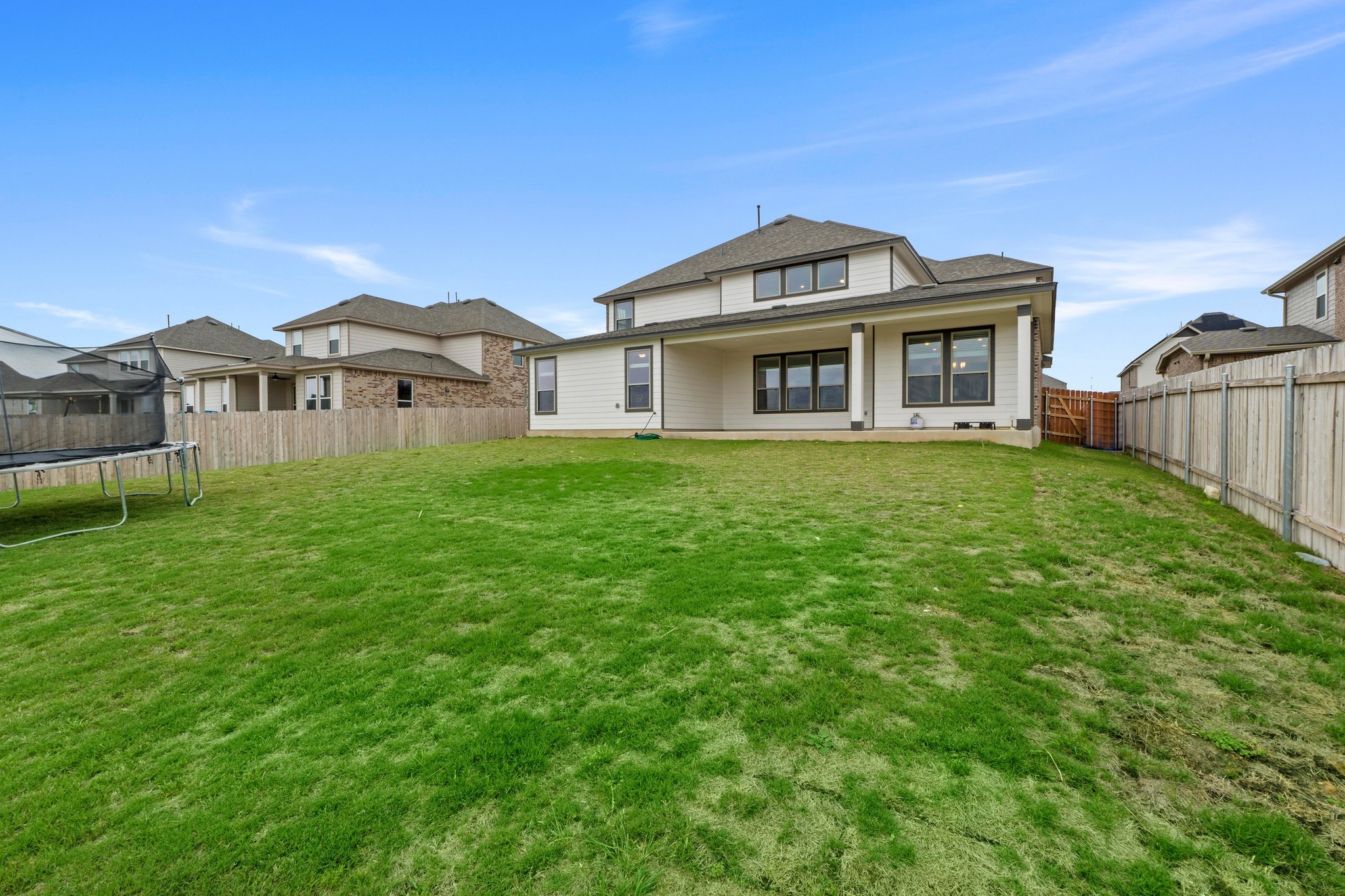 4729 San Rufo Drive Round Rock, TX 78665 - Photo 35 of 36 Expansive grassed yard with a two-story residence featuring a covered patio