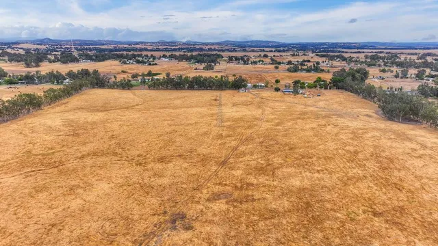 an aerial view of residential building and ocean view in back
