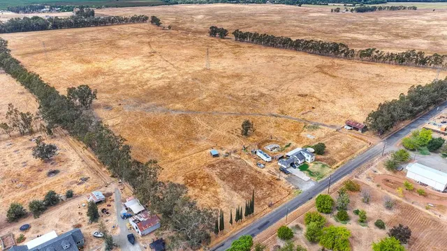 a view of a yard with wooden fence